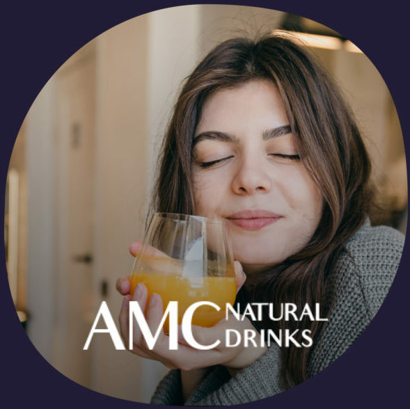 A woman enjoying a glass of juice, emphasizing natural and healthy beverages.